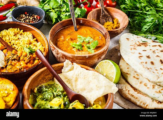 food-traditional-indian-cuisine-dal-palak-paneer-cheese-balls-curry-rice-chapati-chutney-in-wooden-bowls-on-white-background-W5JRM1-1652360785.jpg